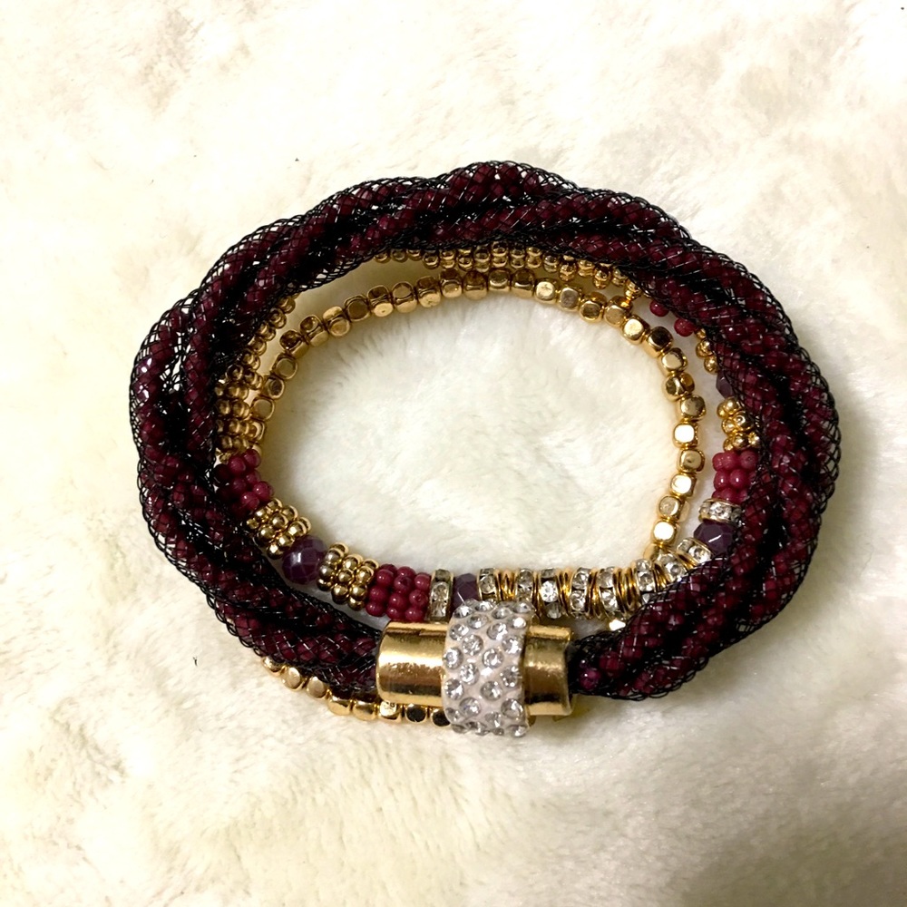Three stretch bracelets in gold and magenta